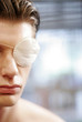 An injured guy with an eye patch on his left eye.