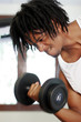 A african american man lifting a dumbbell with his right hand.