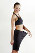 Foto: Side shot of a lady pulling her loose pants. Side shot of a lady pulling her loose pants.