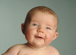 A baby boy smiling.