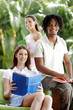 A two ladies and a african american guy holding a book each.