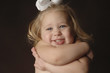 a girl hugging herself.