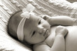 a baby girl with ribbon band.
