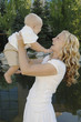 a woman lifting up a baby.