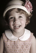 a young girl wearing a hat.