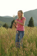 a girl playing with grass.