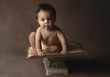 a young boy sitting on a weighing machine.