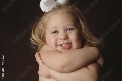 Photo: a girl hugging herself. a girl hugging herself.