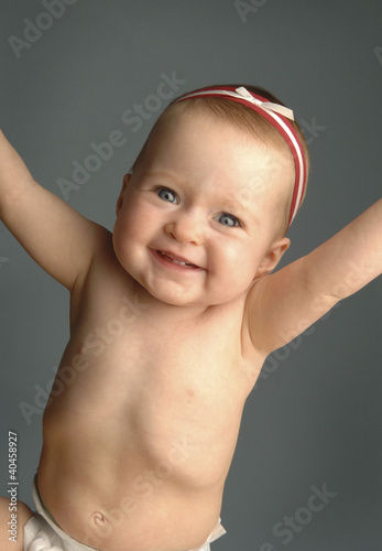 Photo: a cheerful baby girl. a cheerful baby girl.