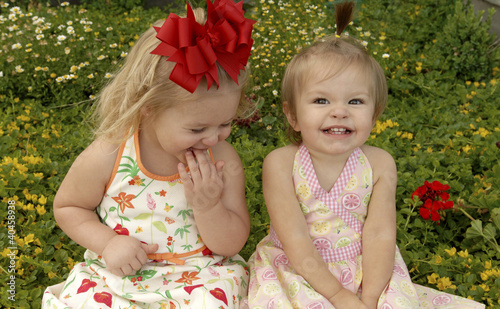 Photo: two girls in a garden. two girls in a garden.