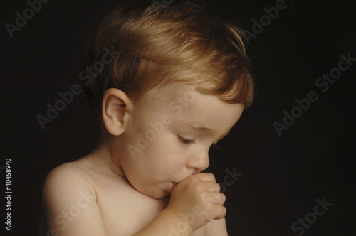 Photo: a boy sucking his thumb. a boy sucking his thumb.