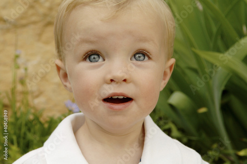 Photo: a young boy looking up. a young boy looking up.