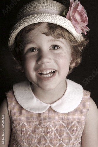 Photo: a young girl wearing a hat. a young girl wearing a hat.