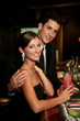 A couple having some drinks at the bar.