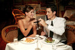 A couple having a toast in the restaurant.
