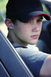 a guy with cap sitting in the car.