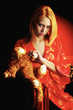 A woman in red bathrobe holding a soft toy.