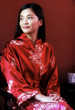 A lady in oriental bathrobe smiling and looking away.