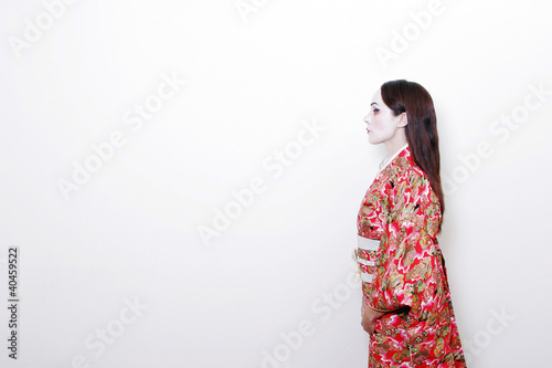 Photo: side shot of a woman in red kimono. side shot of a woman in red kimono.