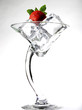 A strawberry on a glass of ice cubes.