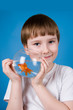 Boy holds a fishbowl with a goldfish