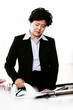 A woman in office attire ironing clothes. 