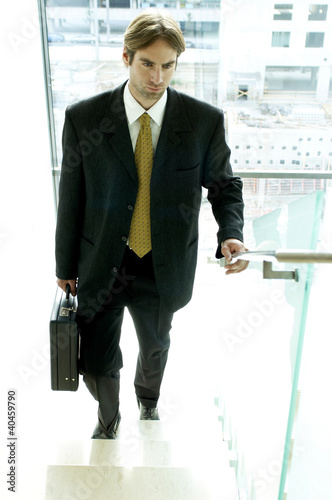 Photo: Businessman walking up the stairs. Businessman walking up the stairs.