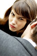 Photo: Woman sulking in front of a man. Woman sulking in front of a man.