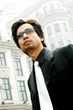 Man in business suit wearing sunglass. 