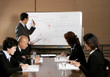 A man teaching while the others writing.