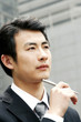 Man in business suit holding a pen. 