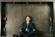 Photo: A man in business suit meditating. A man in business suit meditating.