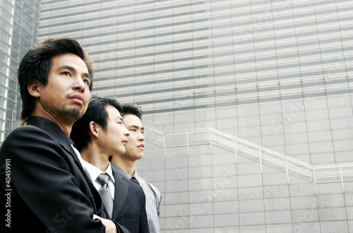 Photo: Three men in office attires. Three men in office attires.