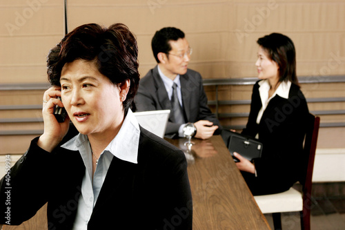 Photo: A woman talking on the handphone. A woman talking on the handphone.