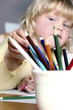 Girl choosing coloured pencils. 
