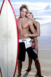 Photo: A couple in swim wear posing for the camera. A couple in swim wear posing for the camera.
