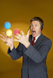 Man trying to juggle with three balls. 