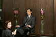 Woman worshipping a man who is sitting on the shelf meditating. 