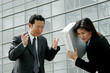 An angry man scolding his assistant. 