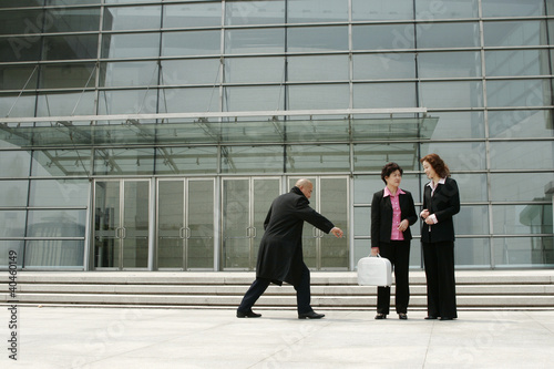 Photo: Bald man trying to snatch a business woman's briefcase. Bald man trying to snatch a business woman's briefcase.