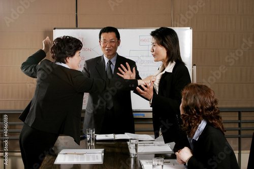 Photo: Manager trying to calm his employees from fighting. Manager trying to calm his employees from fighting.