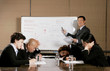 Man and women falling asleep after listening to a dull presentation by the manager.