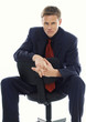 Man in business suit sitting on a chair. 
