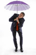 Man in business suit holding an umbrella while checking the weather. 
