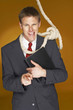 Photo: Businessman pointing at the camera while a rope hanging around his neck. Businessman pointing at the camera while a rope hanging around his neck.