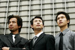 Photo: Three businessmen standing in front of the building. Three businessmen standing in front of the building.