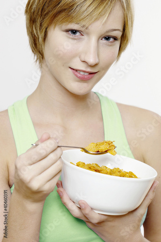 Photo: Woman having cereal breakfast. Woman having cereal breakfast.