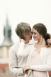 Man giving his girlfriend a peck on the cheek.