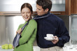 Woman pulling her boyfriend's tie.