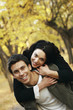 Man giving his girlfriend a piggy back ride.